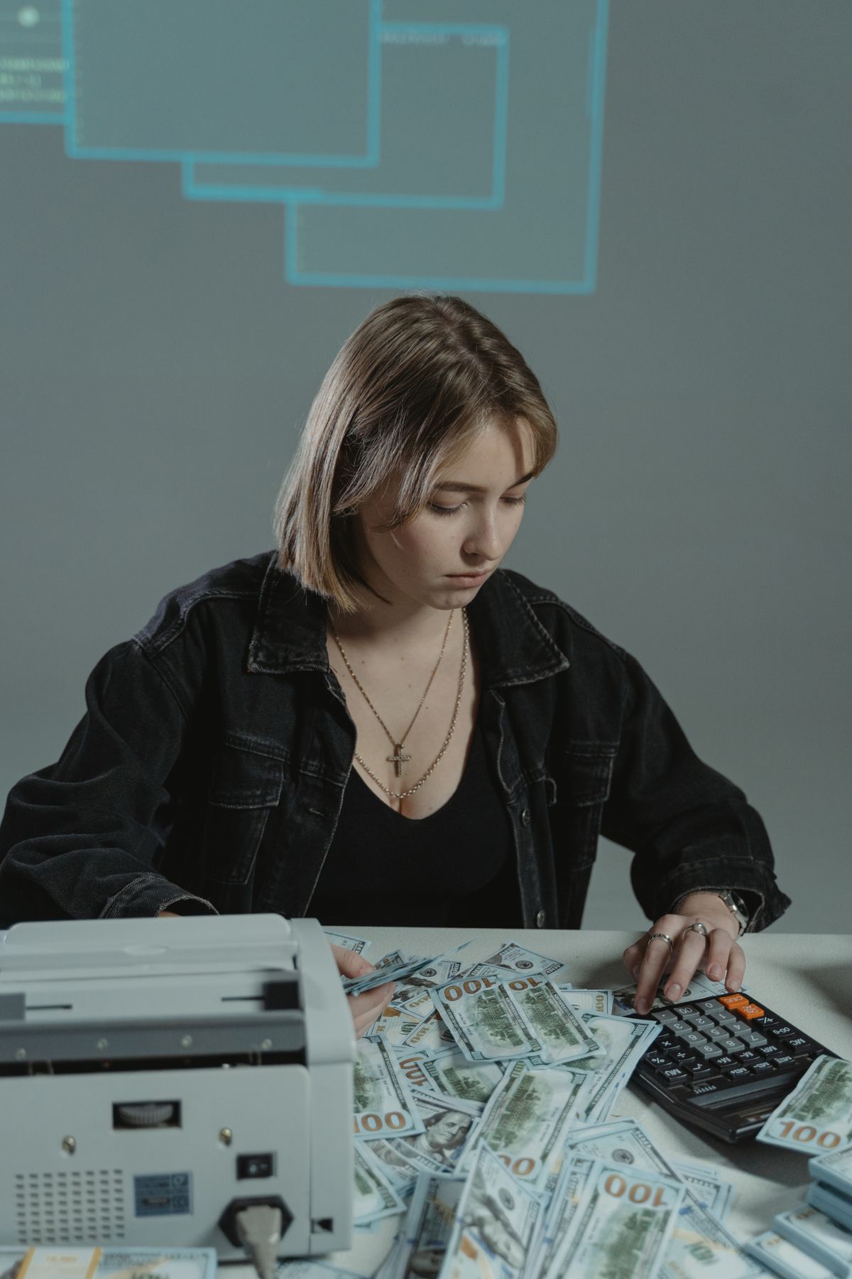 A woman reviewing household money with a calculator