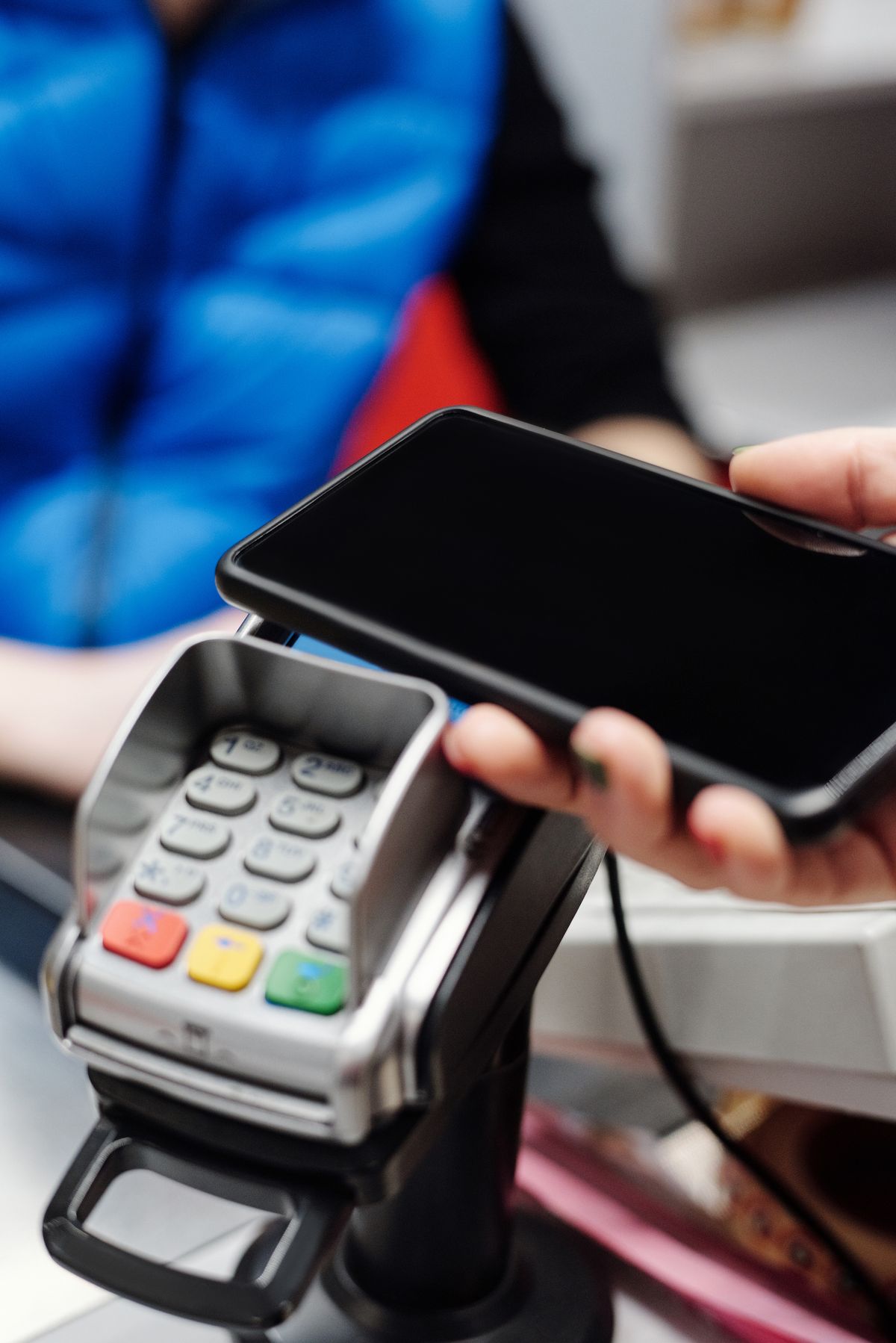 A smartphone being used at a contactless payment terminal