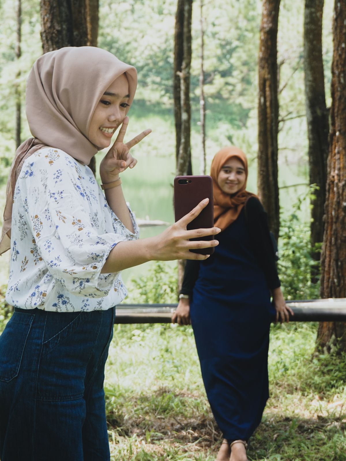 Friends using a smartphone outdoors in Malaysia
