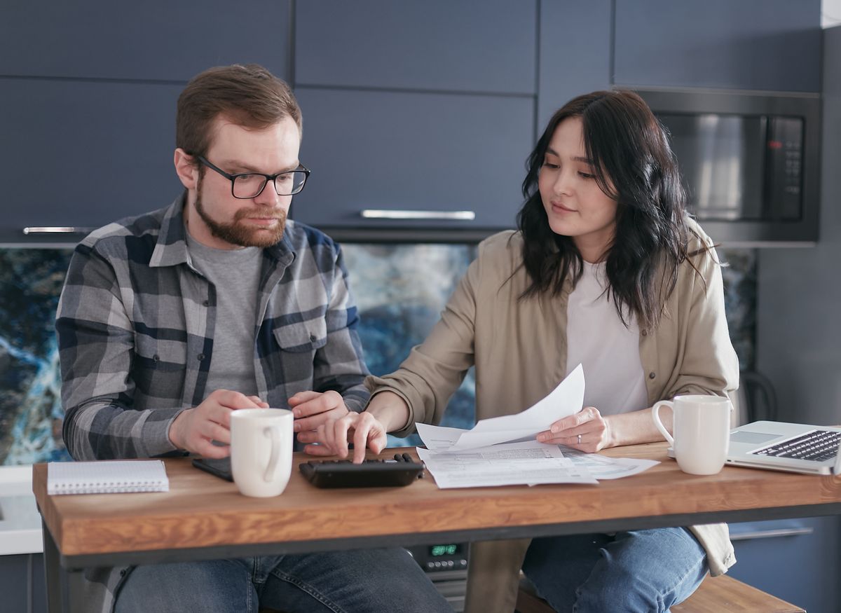 A household reviewing bills and a calculator