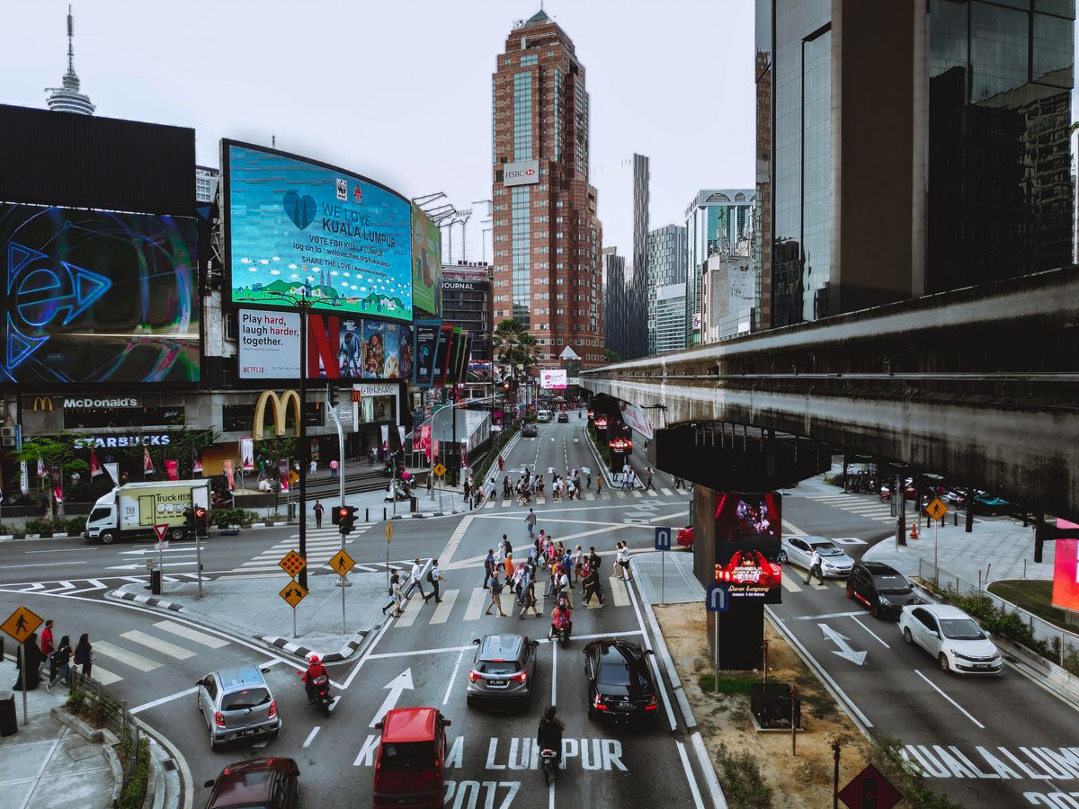 Pedestrians crossing a busy Kuala Lumpur junction