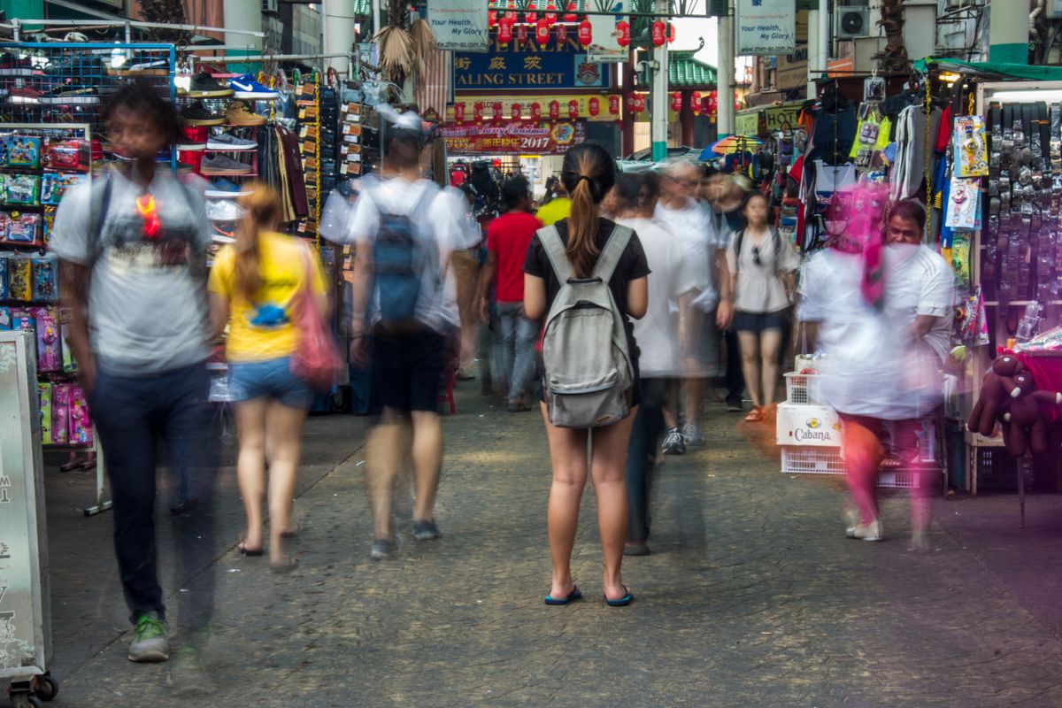 People moving through a busy Kuala Lumpur market