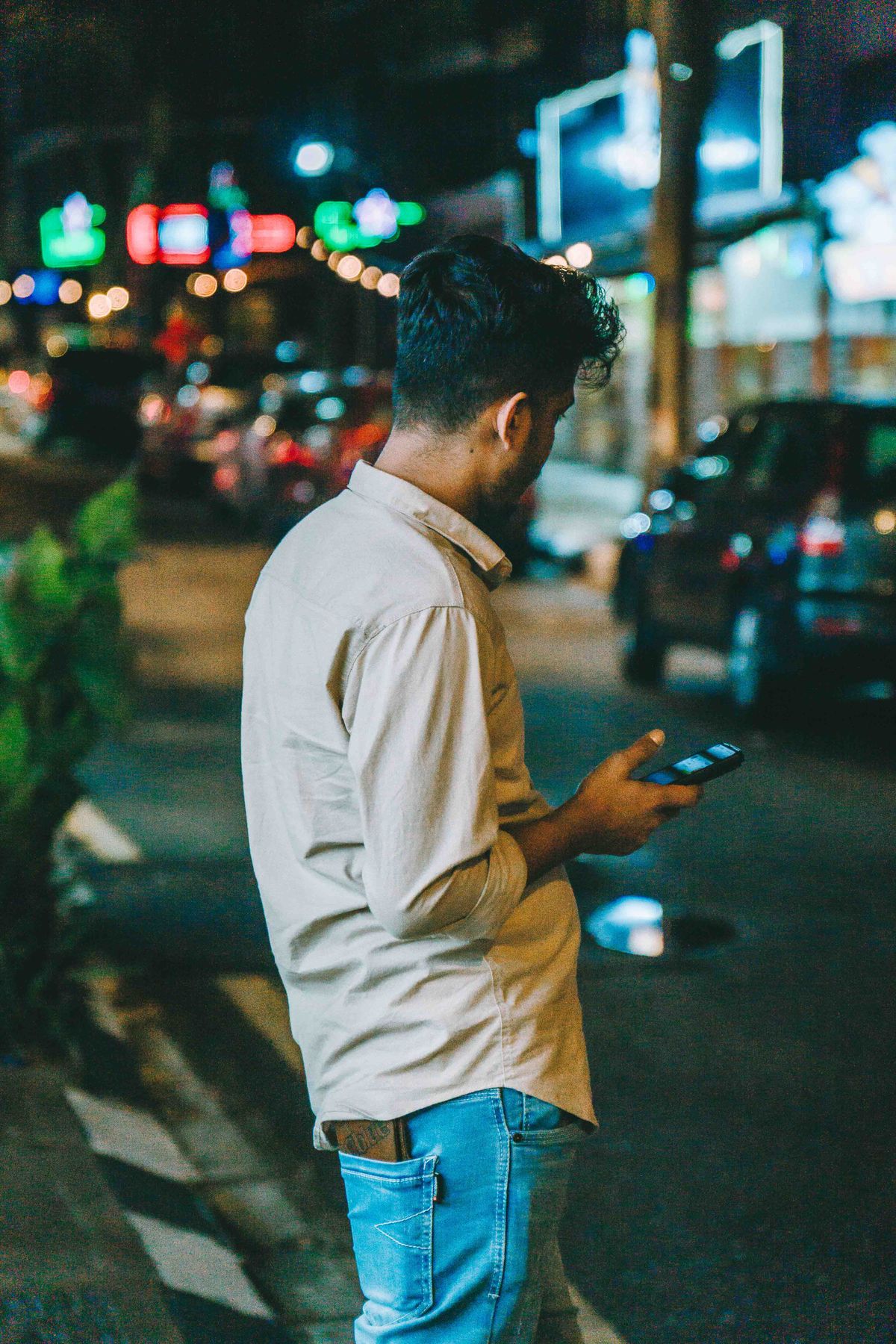 A person using a smartphone on a Kuala Lumpur street